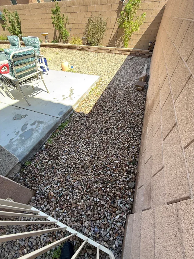 The same gravel run beside the patio slab, picked clean.