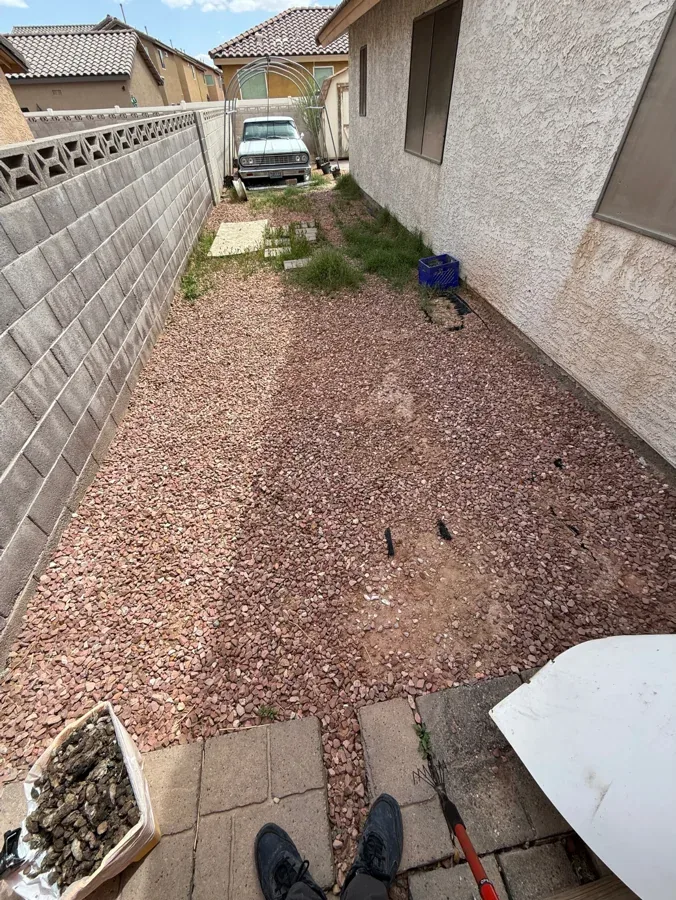 The same long gravel side yard, clean end to end.