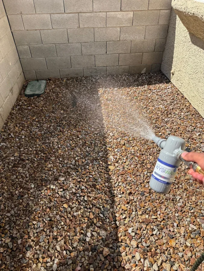 The same gravel corner after the visit, cleared and swept clean.